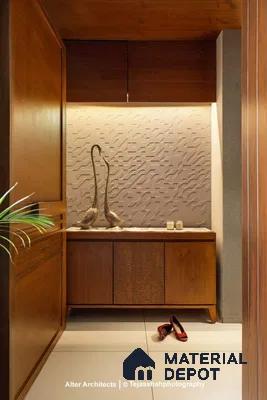 A bathroom with a wooden chair and radiator on the wall next to it in front of a wooden shelf filled with a wooden cabinet and white counter top of a vase filled with plants on the wall next